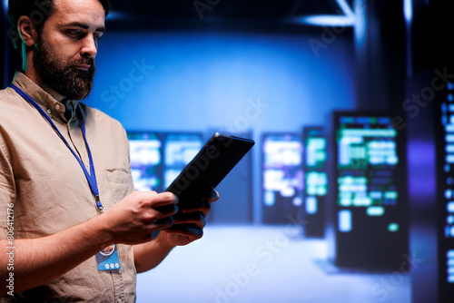Plakat Adept system administrator doing maintenance on interlinked computers creating server network. Data storage service business using parallel computing to perform complex computing operations