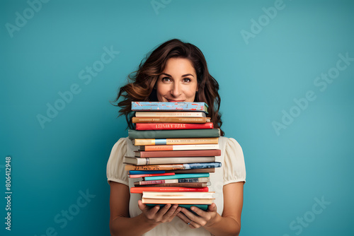 Woman holding an eclectic mix of books for a book swap, against a light blue background, emphasizing community and sharing, Generative AI, photo
