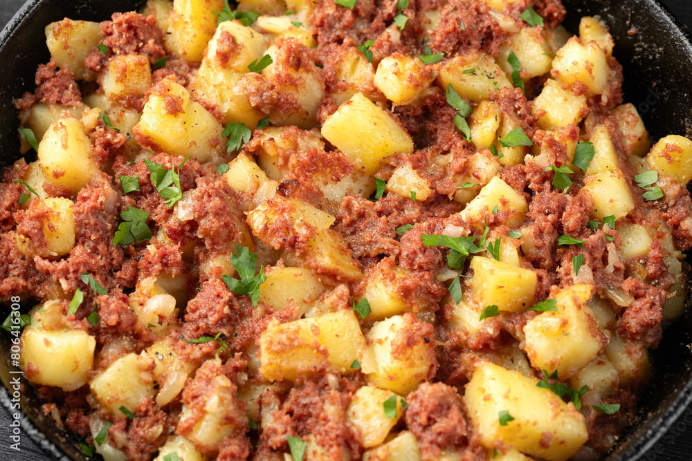 Corned beef hash with potatoes in iron cast pan Corned beef hash with potatoes in iron cast pan