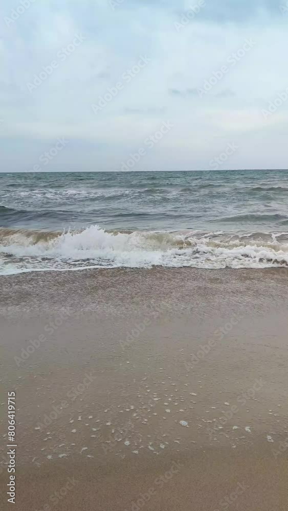 Static shot of the ocean with calm waves reaching the shore of a white sand beach on a tropical island during bright sunny day. Static shot of the ocean with calm waves reaching the shore of a white sand beach on a tropical island during bright sunny day.