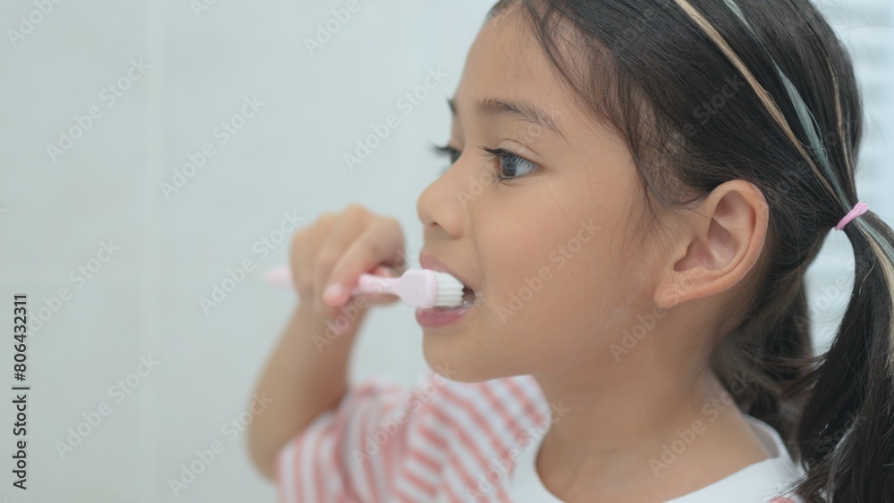 A young girl is brushing her teeth A young girl is brushing her teeth