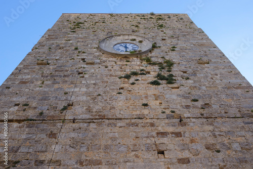 View of the Torre del Candeliere, a medieval tower with clock. Massa Marittima, Grosseto, Tuscany, Italy photo