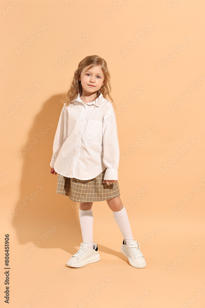 Fashion concept. Stylish girl on pale orange background Fashion concept. Stylish girl on pale orange background