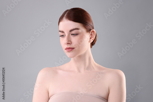 Portrait of beautiful woman on grey background