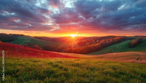 Rolling hills ablaze with the colors of autumn, stretching beneath a vibrant sunset sky