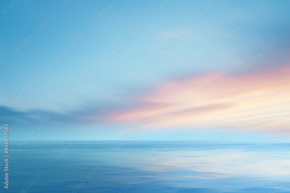A beautiful blue ocean with a pink and orange sky in the background