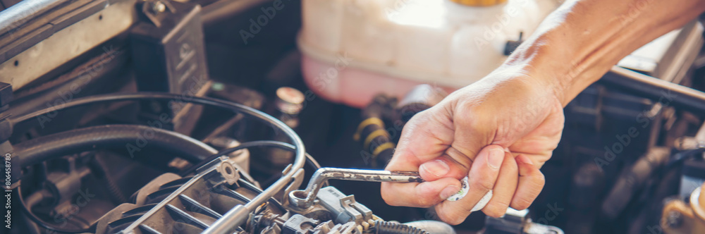 Banner Mechanic man hands repairing car shop. Man hands fixing Car machinery vehicle mechanical service. Panorama open vehicle hood checking up auto mobile. Car maintenance engineer with copy sapce