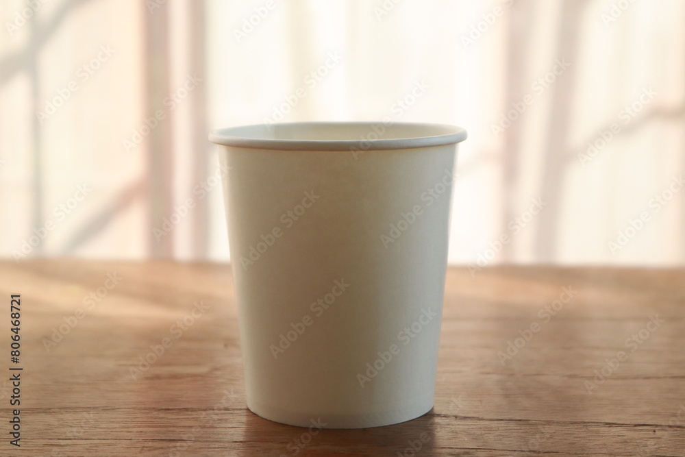 On this desk, amidst an office background, sits a coffee cup, offering a blank space for ideas. It's a modern workplace. On this desk, amidst an office background, sits a coffee cup, offering a blank space for ideas. It's a modern workplace.