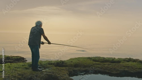 Fisherman casting bait into ocean