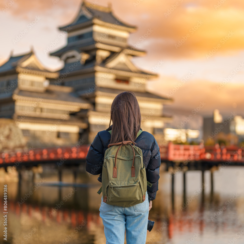 Woman tourist Visiting in Matsumoto, happy Traveler sightseeing Matsumoto Castle or Crow castle. Landmark and popular for tourists attraction in Matsumoto, Nagano, Japan. Travel and Vacation concept