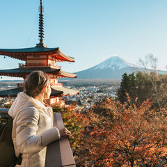 Woman tourist with mount Fuji at Chureito Pagoda in Autumn season, Traveler travel Arakurayama Sengen Park, Yamanashi, Japan. Landmark for tourist attraction. Japan Travel, Destination and Vacation