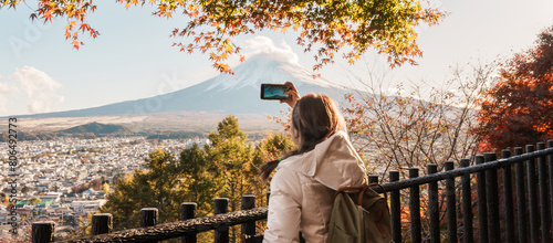 Woman tourist with mount Fuji at Chureito Pagoda in Autumn season, Traveler travel Arakurayama Sengen Park, Yamanashi, Japan. Landmark for tourist attraction. Japan Travel, Destination and Vacation photo