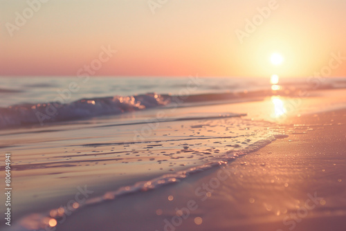 Depicting the allure of a sunset on the horizon with a close-up shot of the sun dipping below the sandy beach, painting the sky in a myriad of colors photo