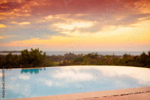 Swimming pool at sunset. Tropical vacation.