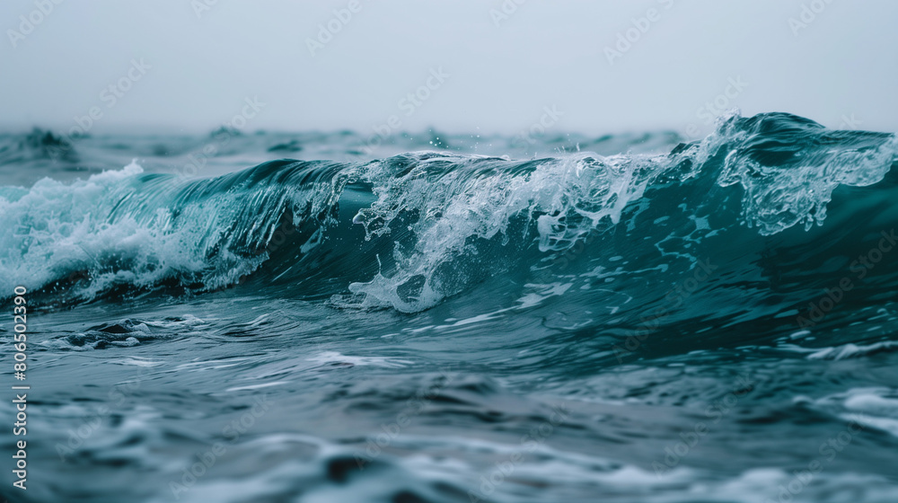 This captivating photograph showcases the raw power and beauty of an ocean wave as it crashes against the shore. The wave, towering and majestic, is captured in a moment of dynamic motion, its frothy This captivating photograph showcases the raw power and beauty of an ocean wave as it crashes against the shore. The wave, towering and majestic, is captured in a moment of dynamic motion, its frothy