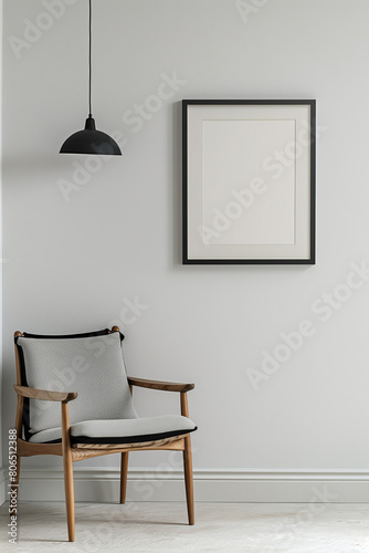 The simulation of a black frame with a white coating contrasts with the plain white wall. and simple furniture 