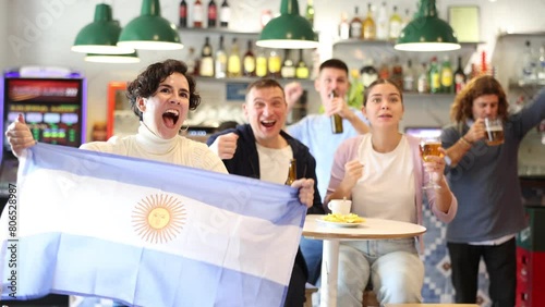Joyful fans of the Argentina team celebrating the victory in the night bar photo
