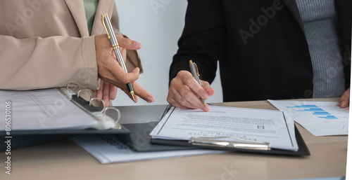 Billede på lærred Two businesswomen sign a business contract together, drafting a company contract document