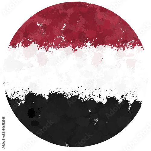 yemeni flag is round with splashes of paint photo