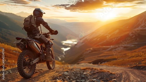 Experienced biker in complete gear riding an off-road motorcycle on a mountain road at sunset. Motocross sport concept.