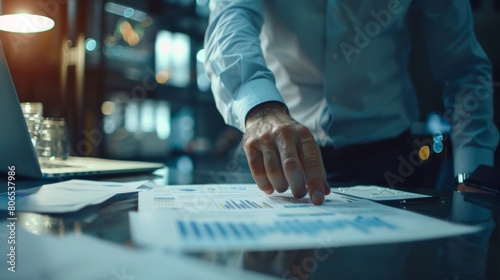 A businessman analyzing financial reports and market research, preparing for a strategic business presentation.