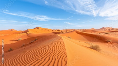 A desert landscape with a blue sky and clouds