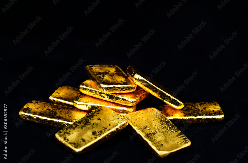 Close up photo a gold bars on black background, copy space Close up photo a gold bars on black background, copy space