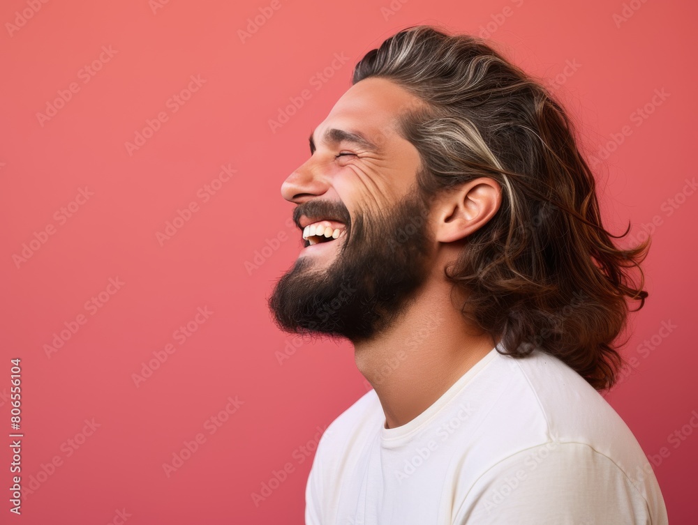 Fototapeta premium A man with a beard and long hair is smiling and laughing