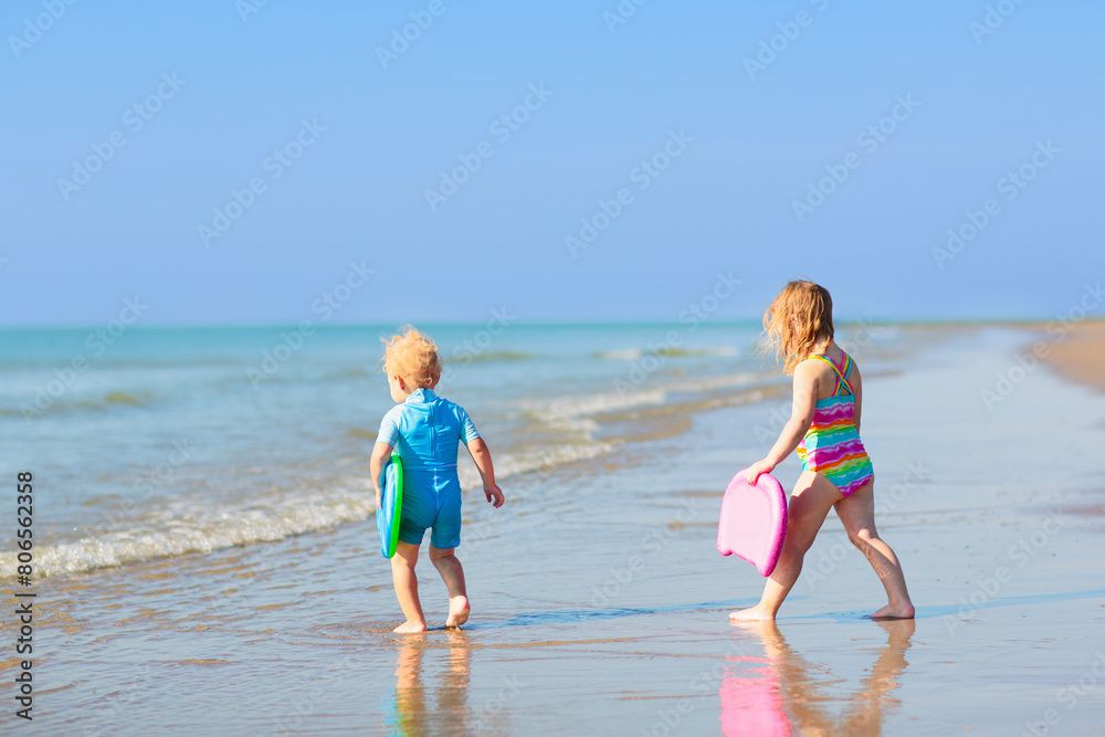 Kids playing on beach. Children play at sea.