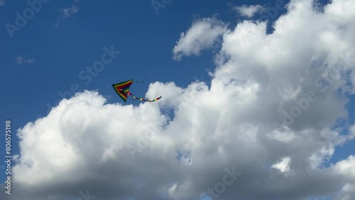 Kite flown in the wind in the sky clouds.