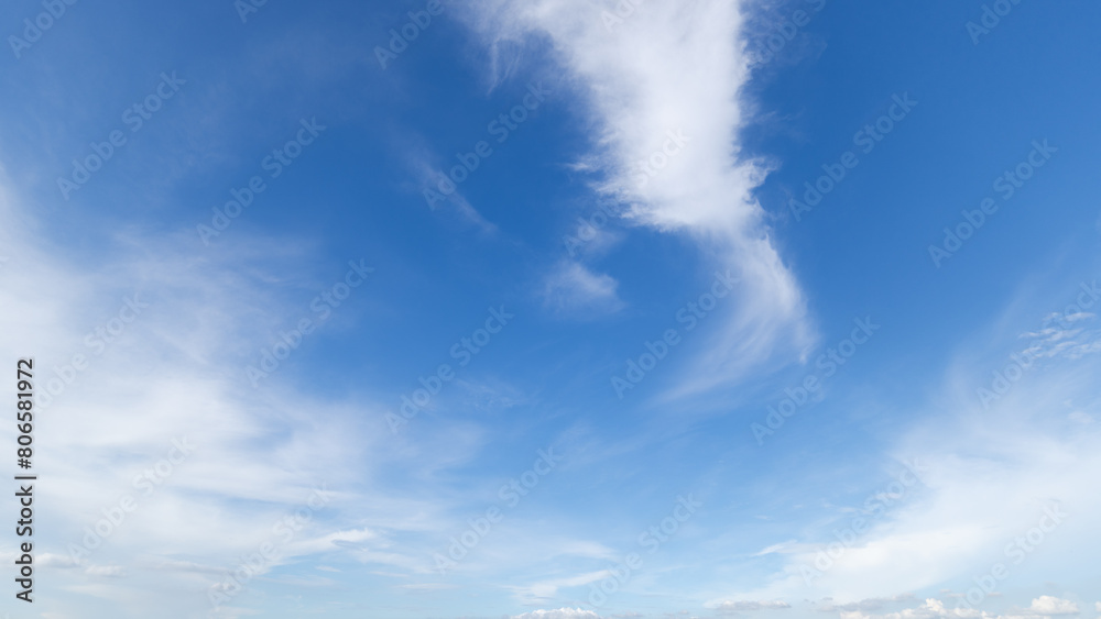 Obraz premium clear blue sky background,clouds with background, Blue sky background with tiny clouds. White fluffy clouds in the blue sky. Captivating stock photo featuring the mesmerizing beauty of the sky and cl