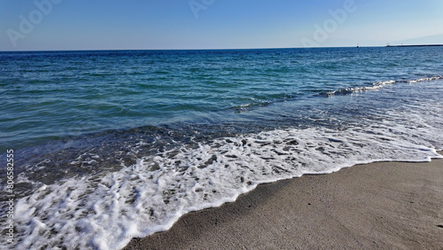 Ocean sea Aegean waters with sandy beach in Greece.