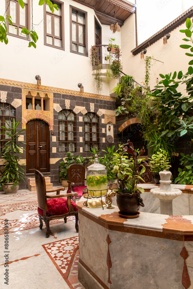 Naklejka premium Interior of luxury hotel in oriental style with living plants and fountain in the lobby