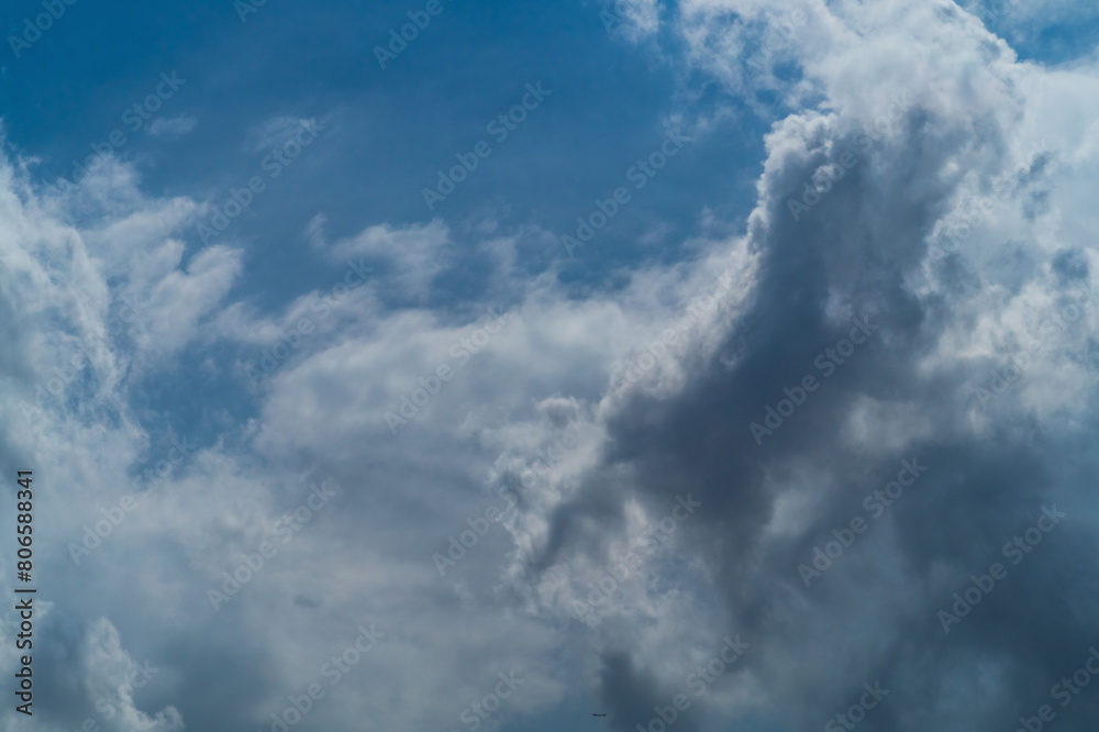 Dense, heavy clouds with rain potential move across the sky. Precipitation due to a decrease in atmospheric pressure to the point of dew