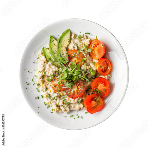 Oatmeal with avocado and tomato topping in white plate, top view, on a transparent background photo