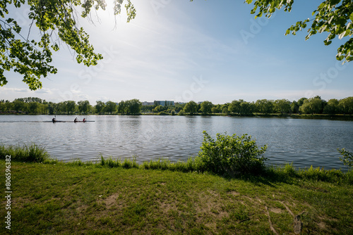 Valley of the Three Ponds in Katowice. Green areas in the city. Recreation zone. Kayakers floating on the city pond..Residential buildings in the background