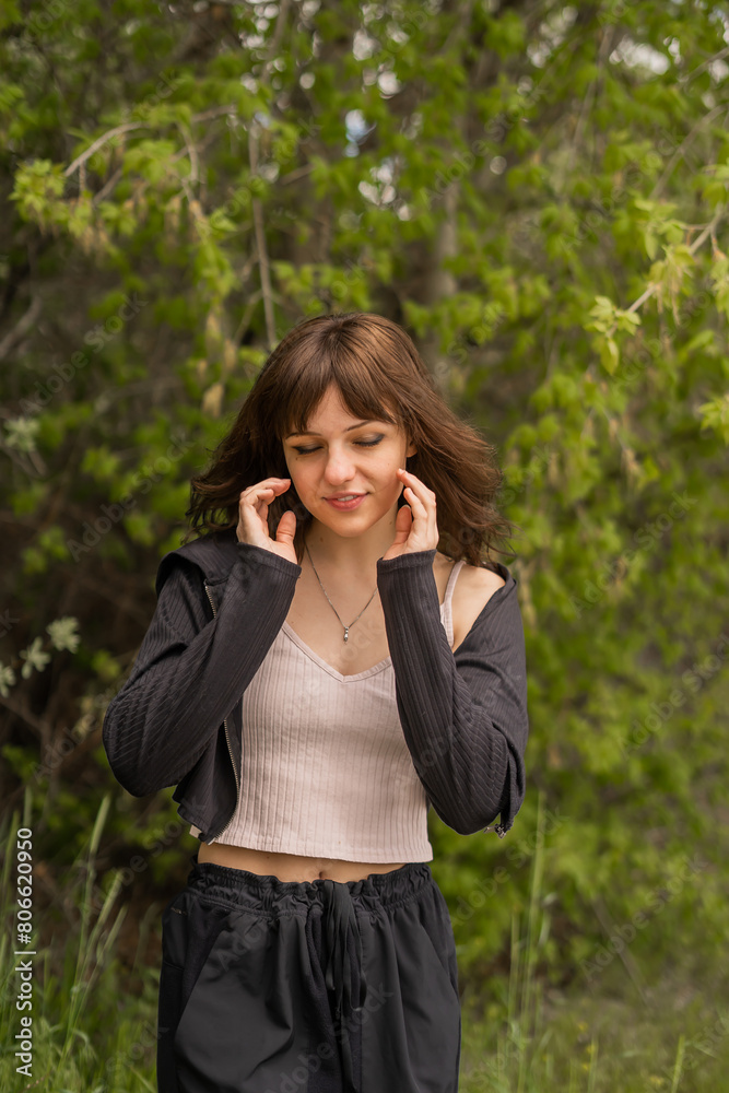 Girl Eyes Closed Soft Smile On Walk Jog Nature Hike Black Sweats Black Jacket Dark Brown Hair Fringe