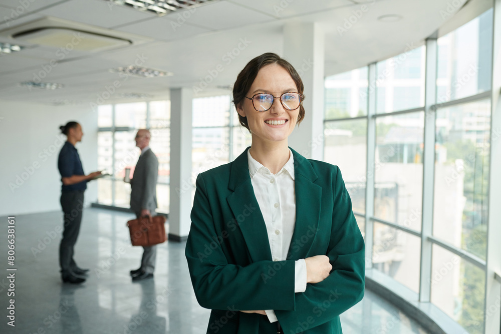 Portrait of smiling confident female entrepreneur standing in new spacious office Portrait of smiling confident female entrepreneur standing in new spacious office