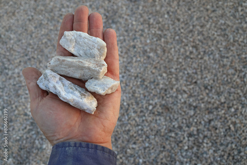 Photos Spodumene pegmatite ore held in hand