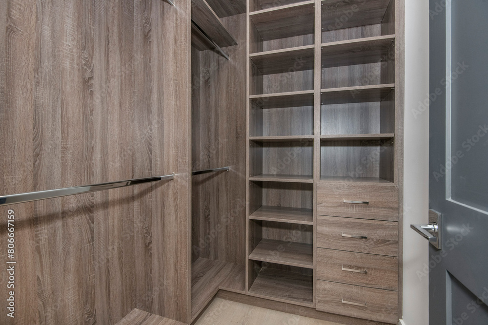 Open wooden closet with drawers in a modern new construction home in Los Angeles