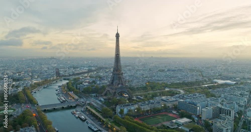 Beautiful view of famous Eiffel Tower in France with magical morning cloud and fog. Wide establishing aerial drone fly over seine river in paris city center, best travel destination landmark in Europe