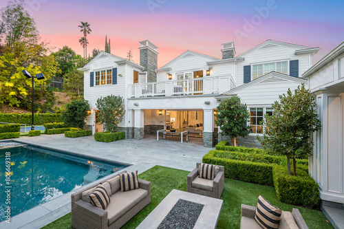 Large pool in front of a white house in Encino, California