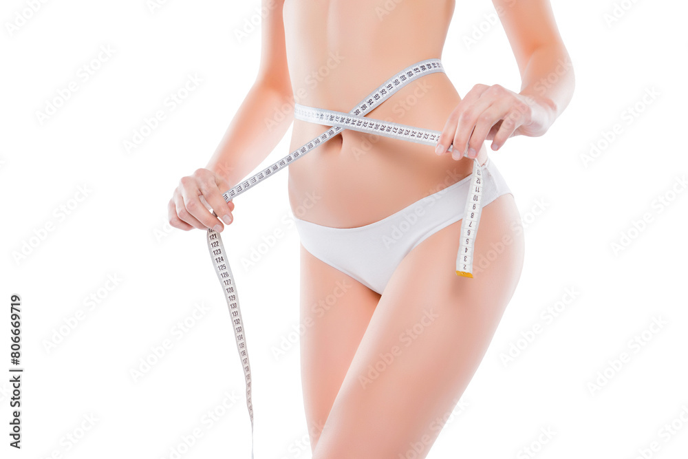 Cropped close up photo of fatless slender body parts and proportions woman's hands holding white centimeter measuring waistline isolated on background