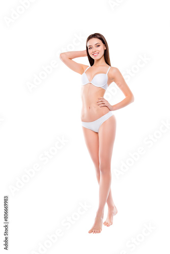Vertical fullsize length portrait of stunning graceful gentle girl with ideal sportive figure shape having thin legs smooth soft flawless skin isolated on white background. Waistline tummy concept photo