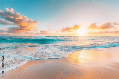 Golden sunlight reflecting on gentle ocean waves and sandy beach