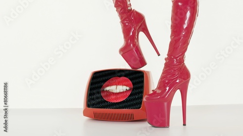 female legs in red high heel stilettos and retro television