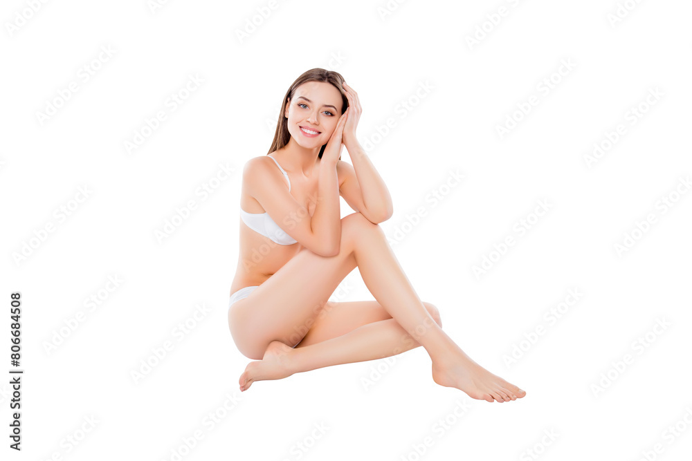 Portrait of thin slender woman sitting over white background in bra and bikini looking at camera demonstrating perfect body plain skin Portrait of thin slender woman sitting over white background in bra and bikini looking at camera demonstrating perfect body plain skin