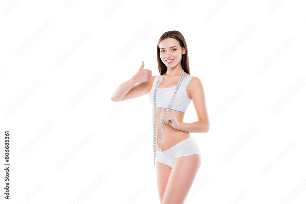 Portrait of positive girl with perfect body gesturing thumbup symbol having measuring tape on neck isolated on white background. Weightloss concept Portrait of positive girl with perfect body gesturing thumbup symbol having measuring tape on neck isolated on white background. Weightloss concept