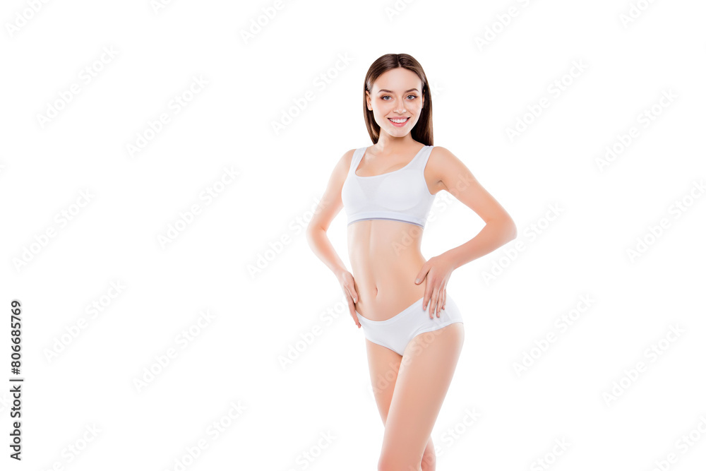 Portrait of thin slender woman with perfect body in white cotton underwear bikini isolated over white background holding hands on waist showing her ideal belly Portrait of thin slender woman with perfect body in white cotton underwear bikini isolated over white background holding hands on waist showing her ideal belly