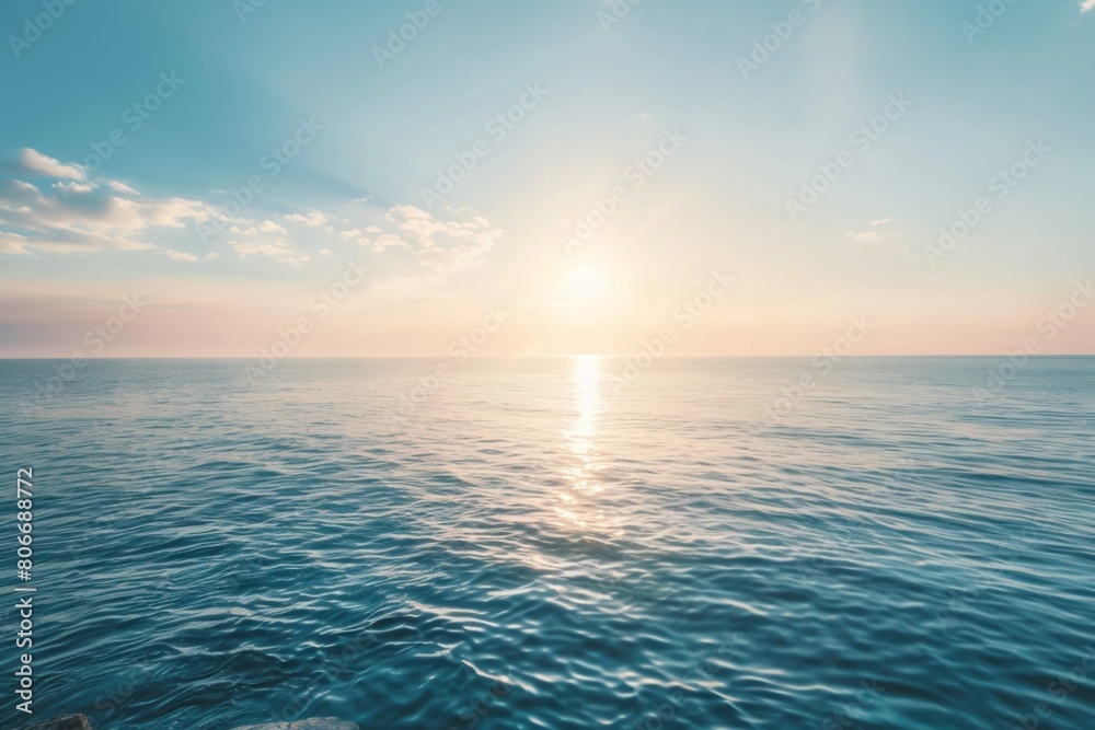 Sunlit rocky coastline with calm sea at sunset